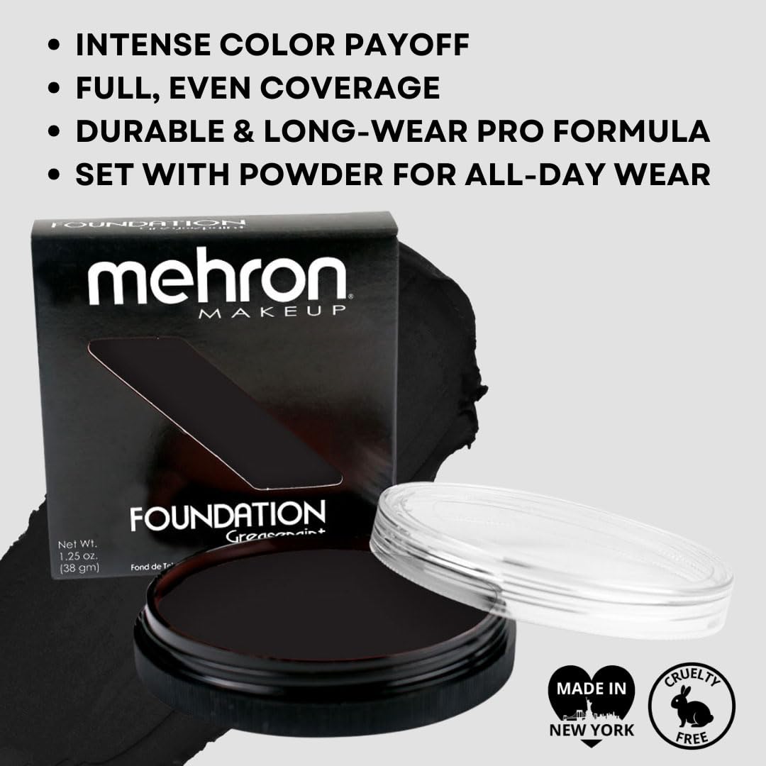 Mehron greasepaint black application with brush showing precise control and bold coverage