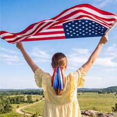 melyde hand holds ribbon hair tie to show 12-inch length and scale