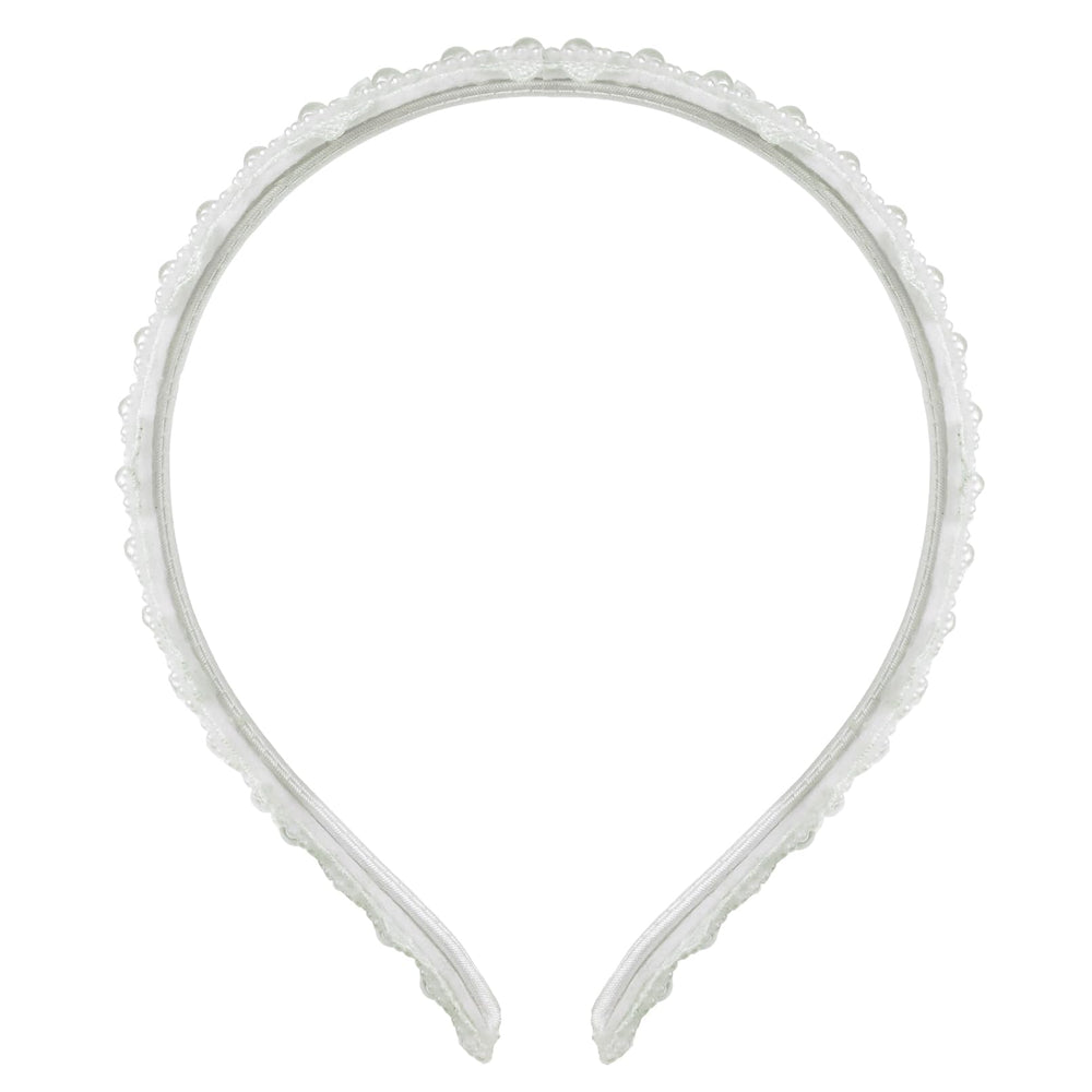 Merroyal close-up showing lace pattern and pearl beads, delicate detail