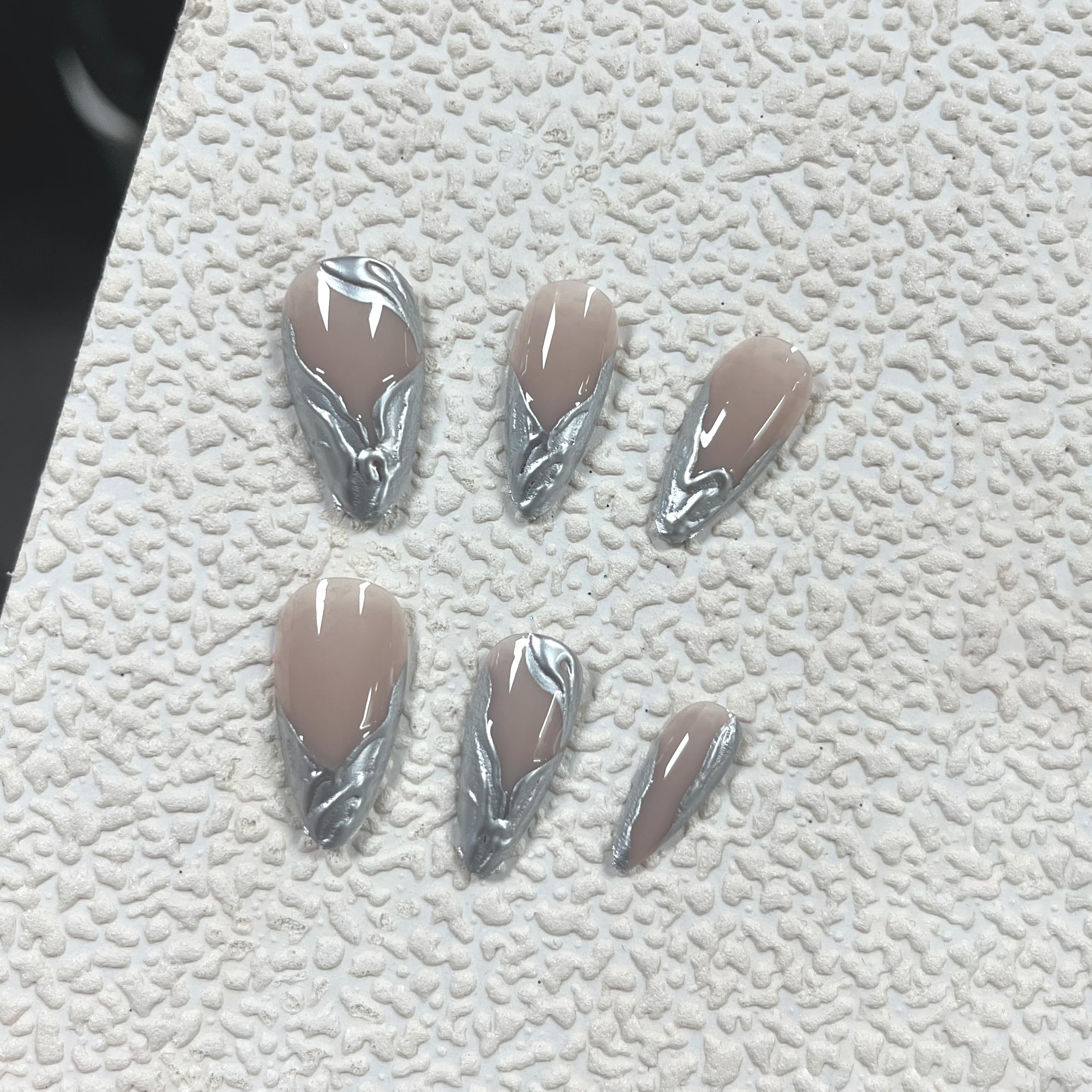 MERVF close-up of chrome French tip and 3D silver detail for reflective style