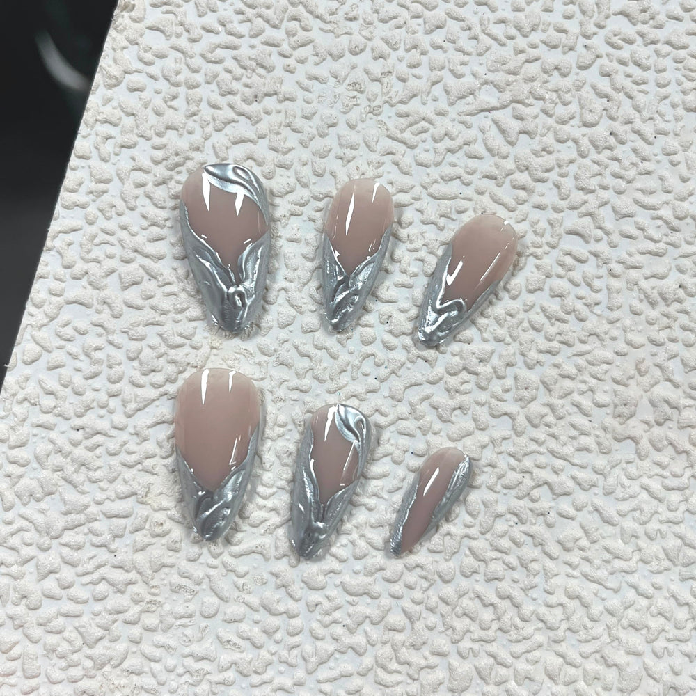 MERVF close-up of chrome French tip and 3D silver detail for reflective style