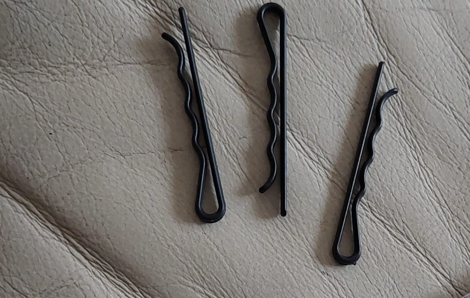 Metal Free Styling pins in a travel kit near passport and boarding pass, security-friendly