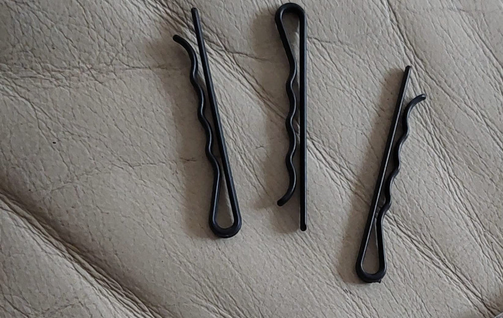 Metal Free Styling pins in a travel kit near passport and boarding pass, security-friendly