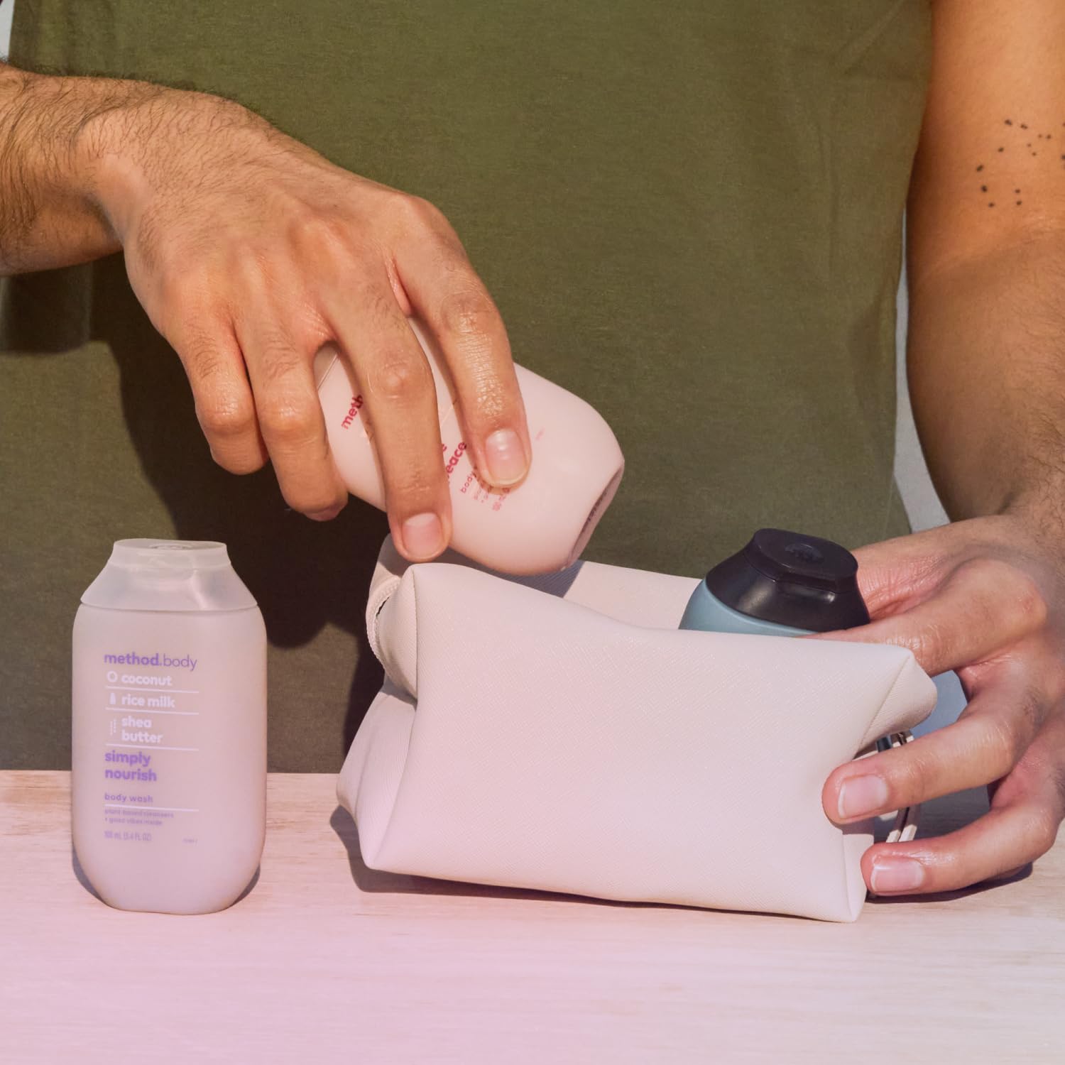 Method three bottles beside travel bag demonstrating TSA-ready size