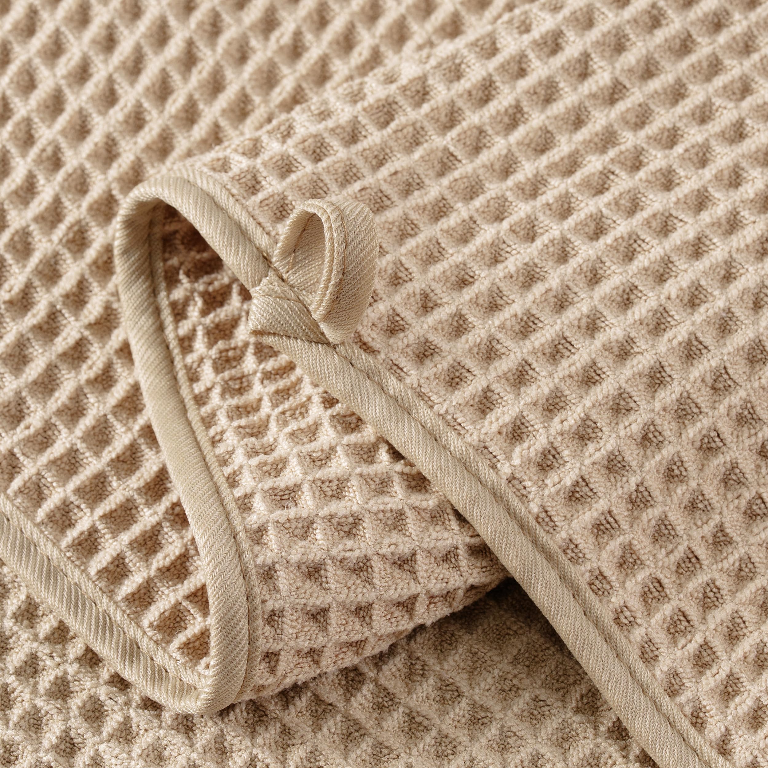 MICROFI towel held in hand showing 12x12 scale and travel-friendly convenience
