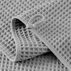MICROFI towel folded next to ruler showing size and space-saving benefit