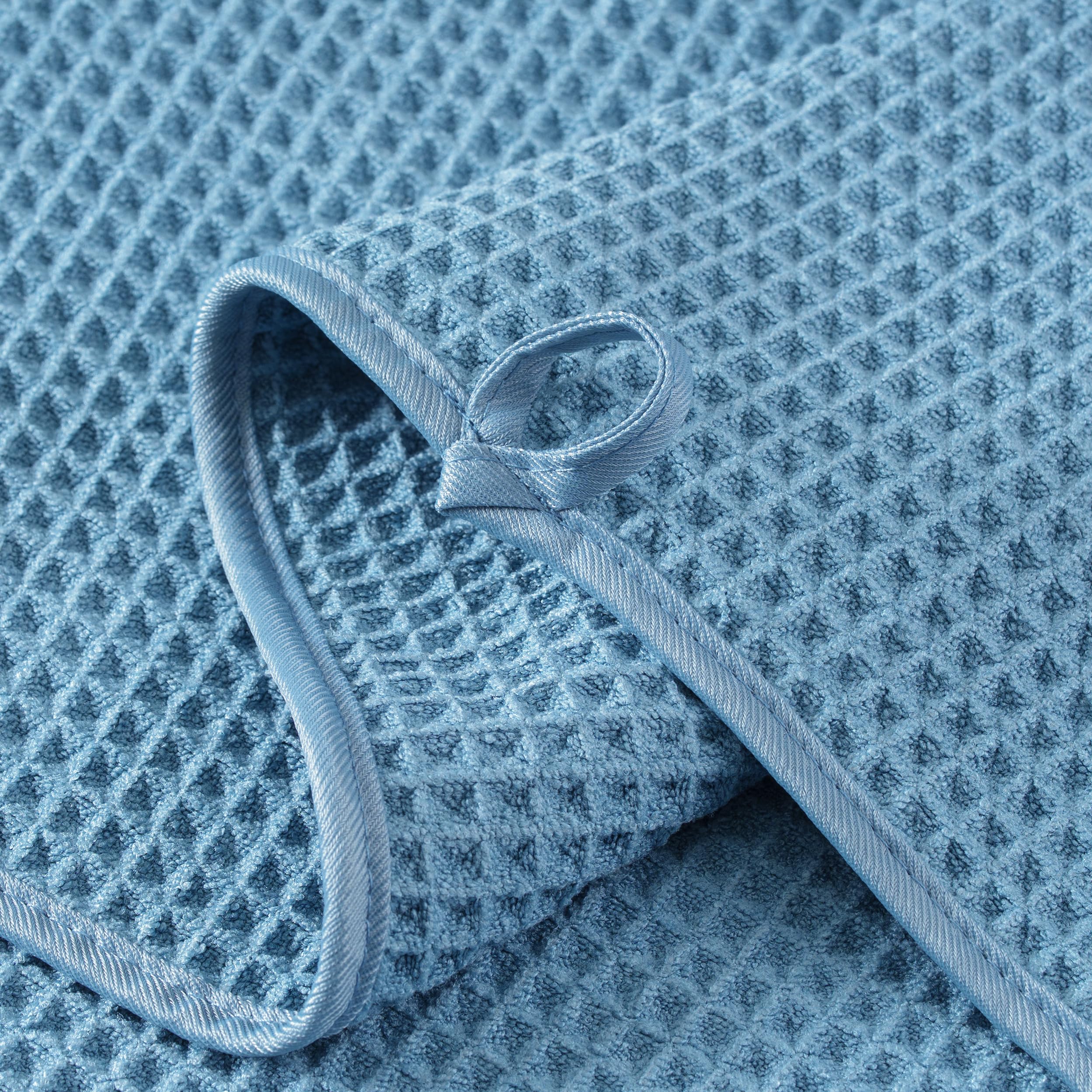 MICROFI neatly folded stack of four towels showing space-saving storage benefit