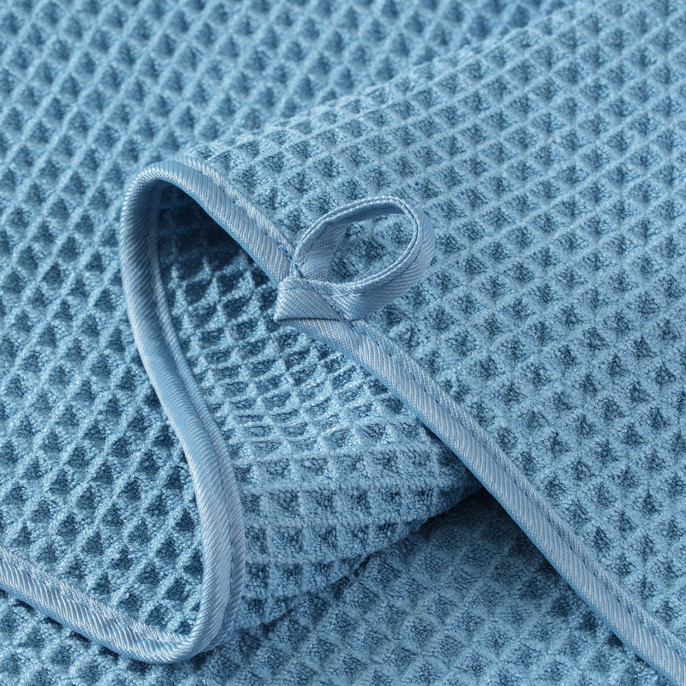 MICROFI neatly folded stack of four towels showing space-saving storage benefit
