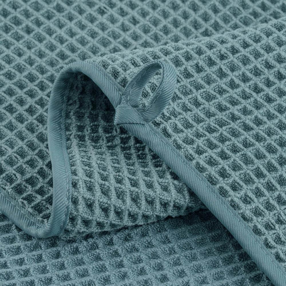 MICROFI towel beside ruler showing 12x12 inches size and portability benefit