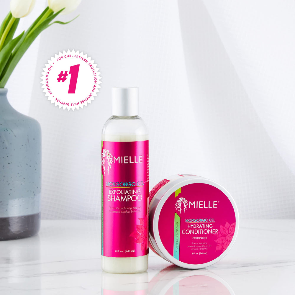 Mielle Organics bottle beside mongongo nuts and oil showing nourishing ingredient
