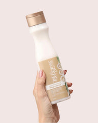 Milagros conditioner texture pouring, demonstrates smoothing and detangling action