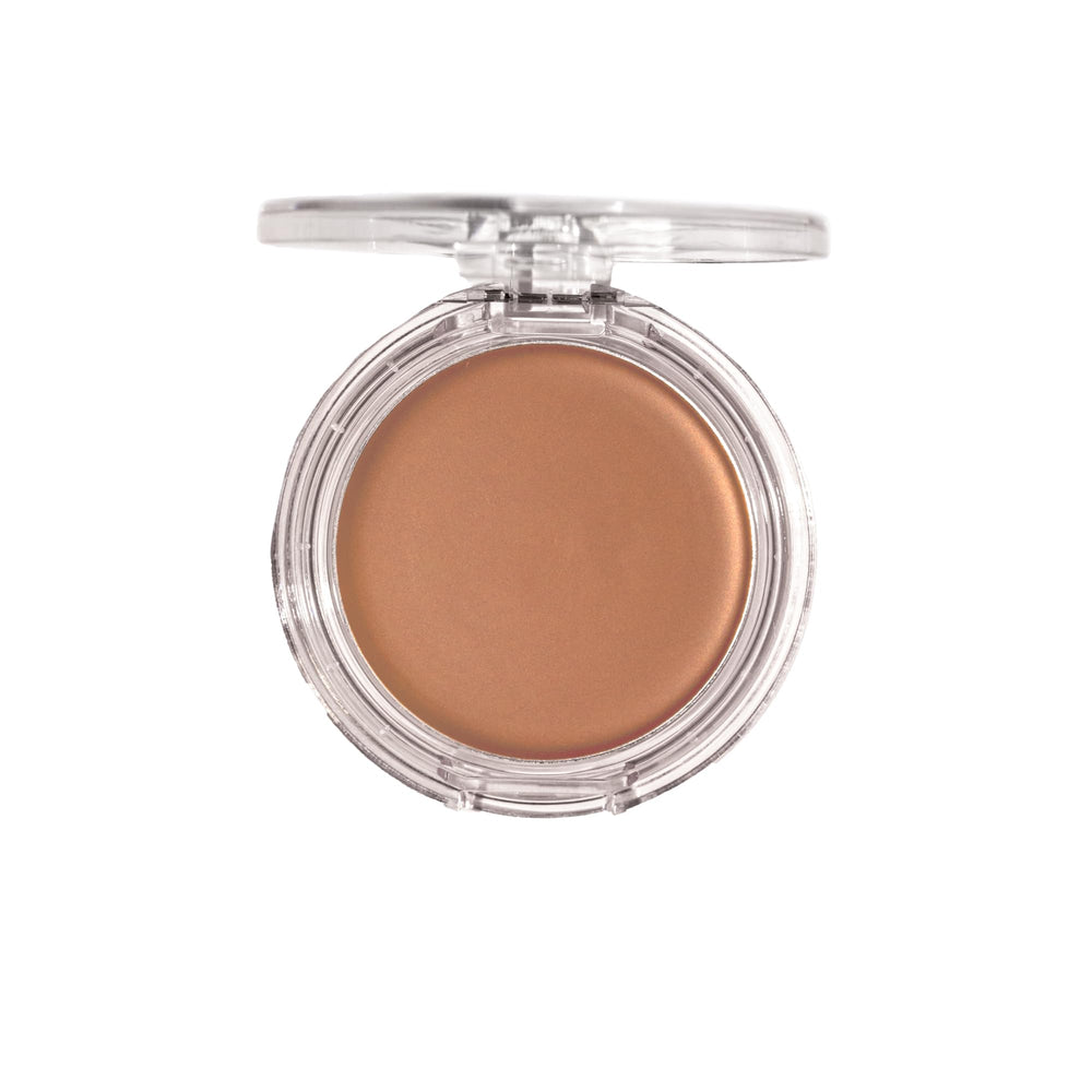 Milani bronzer next to coin for scale showing compact size and travel-friendly benefit