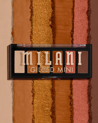 Milani compact closed beside a phone showing travel-friendly size