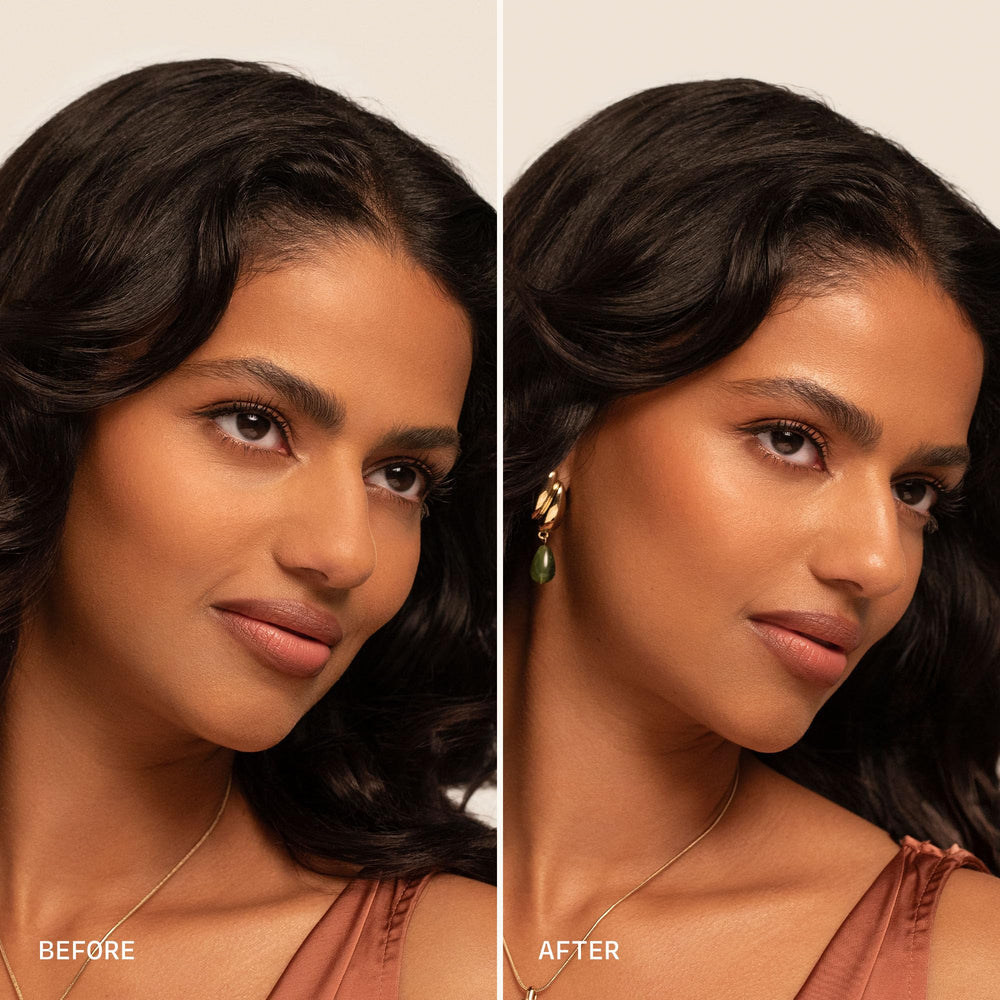 Milani dewy spray placed by foundation and brushes highlighting priming use