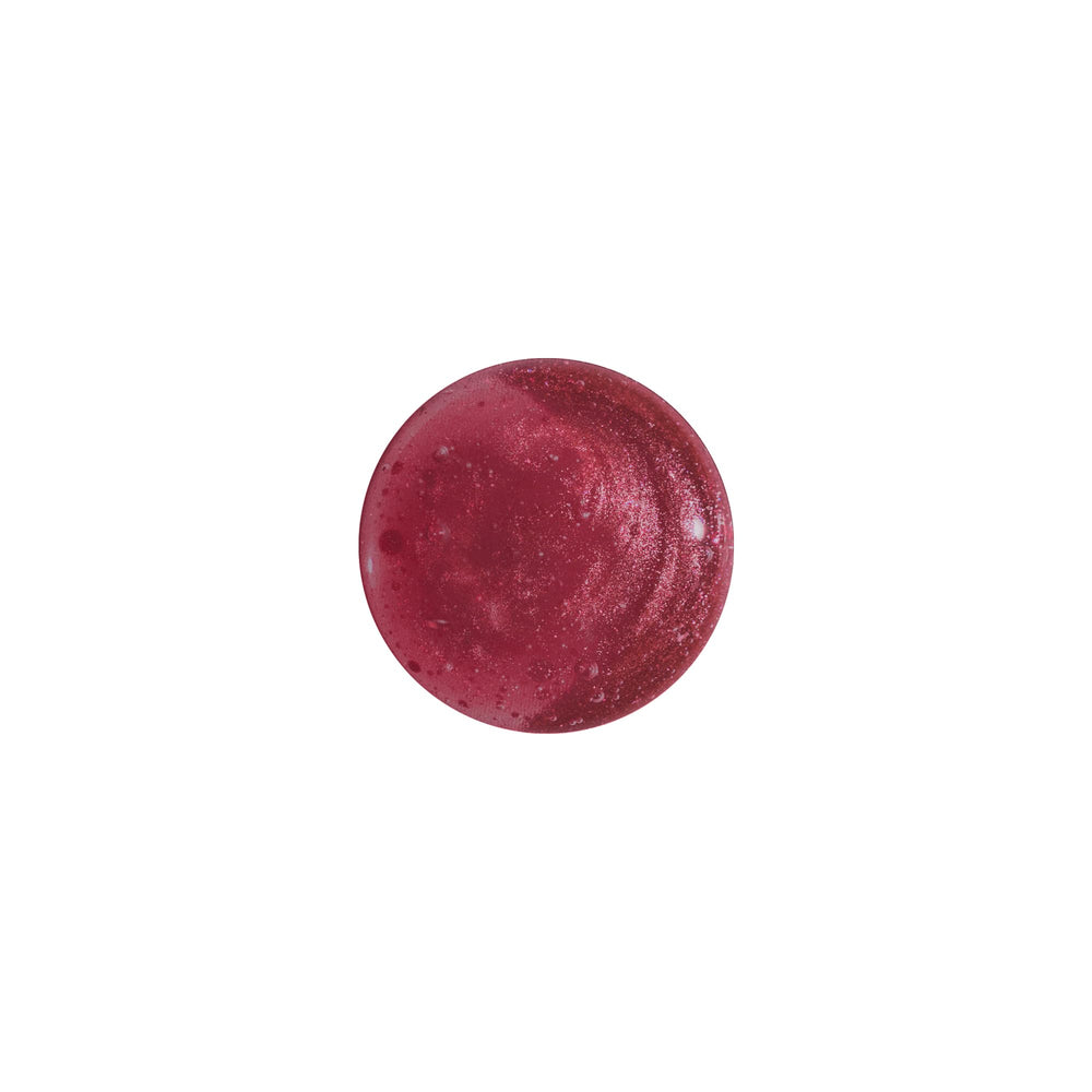 Milani Fruit Fetish worn on lips in lifestyle scene showing sheer tint and high-shine benefit