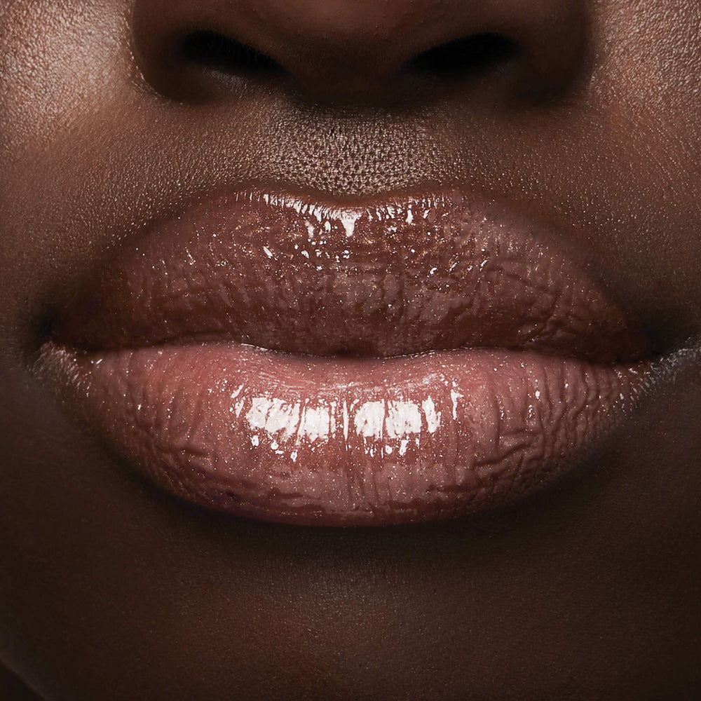 Milani lifestyle bag shot showing gloss ready for on-the-go touch-ups