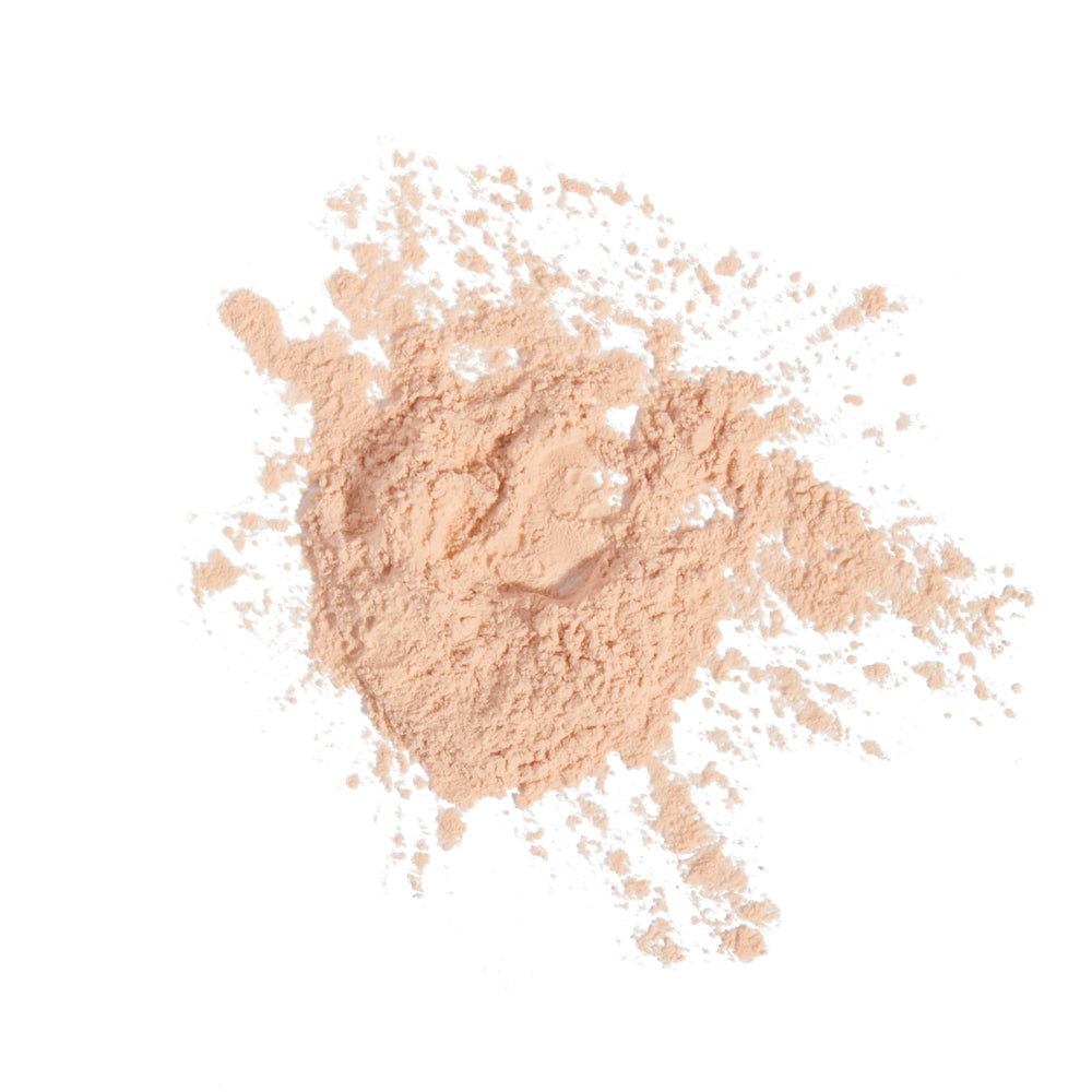Milani powder on vanity with accessories, suggests everyday beauty routine enhancement