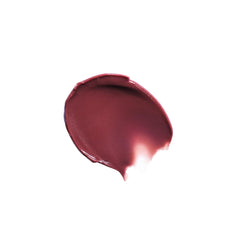 Milani on lips in lifestyle shot showing fuller-looking, glossy finish benefit