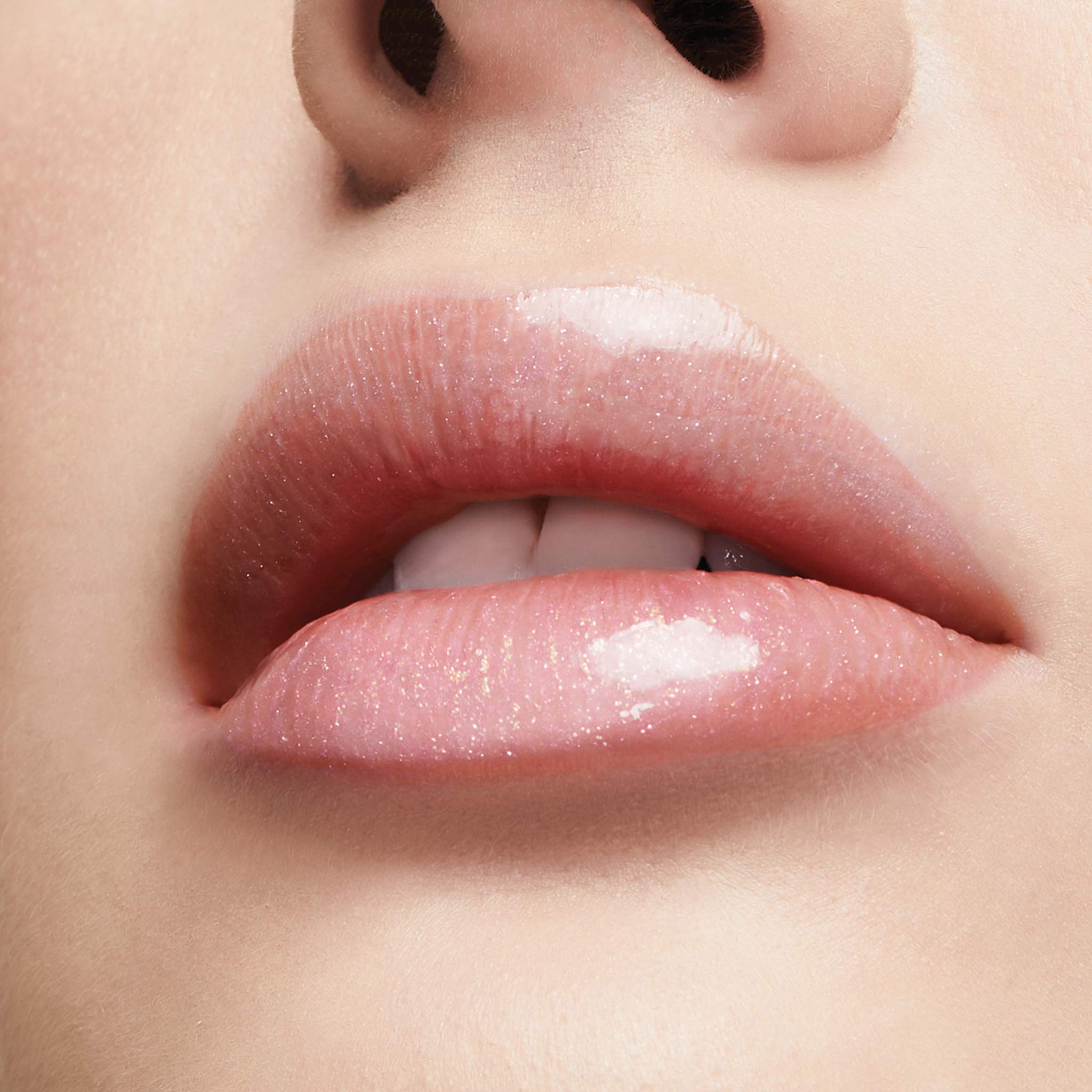 Milani lifestyle model smiling wearing gloss for luminous, fuller-looking lips