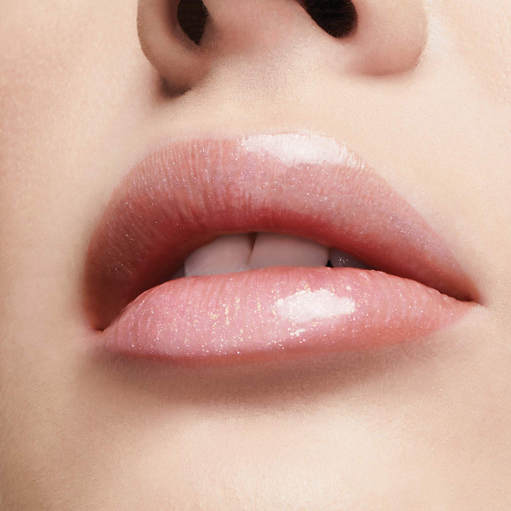 Milani lifestyle model smiling wearing gloss for luminous, fuller-looking lips
