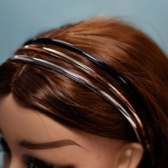 minihope headband held in hand to show scale and portability for on-the-go convenience