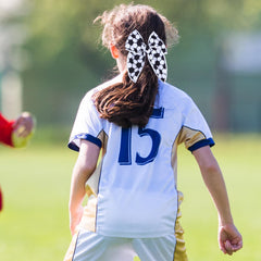Miroksh bow worn in a ponytail highlighting visibility and comfortable wear during play