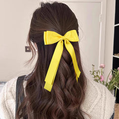 Miroksh bow clipped in ponytail showing instant polished style and movement