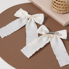Miroksh bride and flower girl wearing bows offering cohesive wedding styling