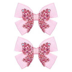 Miroksh front view of two glitter pink bow clips adds sparkle