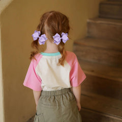 Miroksh bow clipped in ponytail demonstrating festive look and comfortable wear
