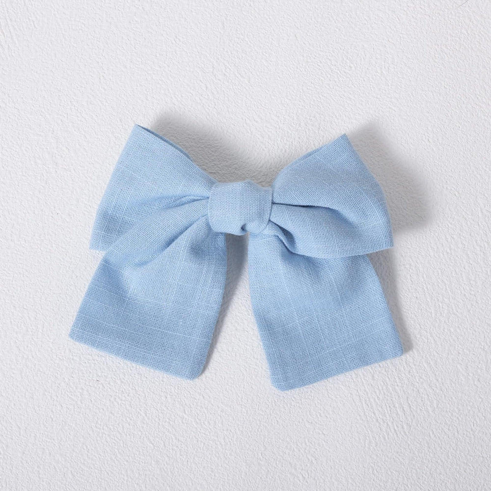 Miroksh bow paired with beach dress showing summery outfit benefit