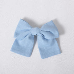 Miroksh bow paired with beach dress showing summery outfit benefit