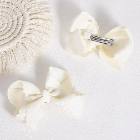 Miroksh scallop close-up highlighting grosgrain texture and polished edge