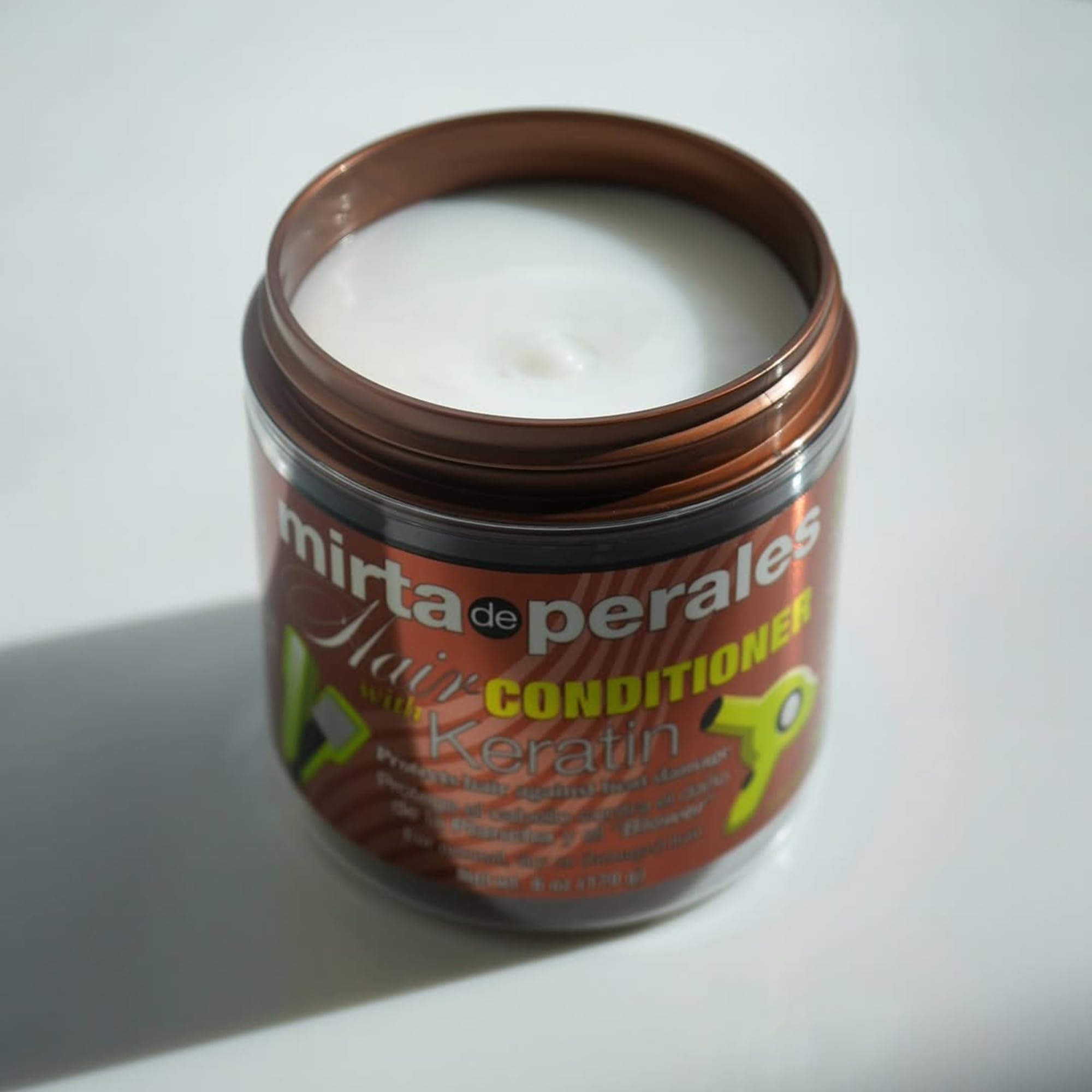 Mirta De Perales on bathroom shelf lifestyle shot showing everyday salon-quality care