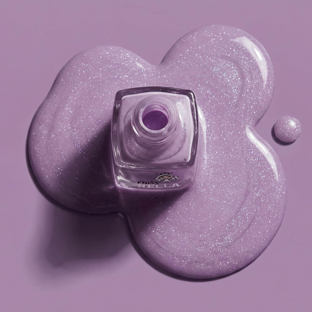 Miss Nella size comparison beside a coin showing compact, travel-friendly bottle