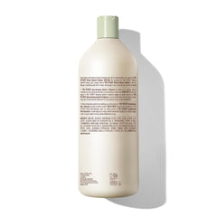 Mizani 33.8 oz bottle beside common items to show scale