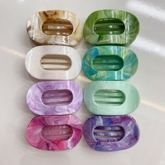 Mobacfy hand holding clips showing scale and portable styling benefit