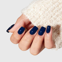 Modelones close-up of nail surface texture illustrating glossy navy finish and durability