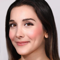 Moira blush tube next to coin showing compact size and travel-friendly benefit