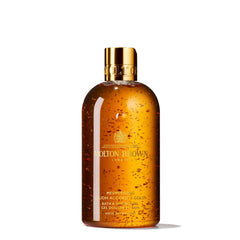 Molton Brown front bottle displaying luxurious amber gel and label benefit