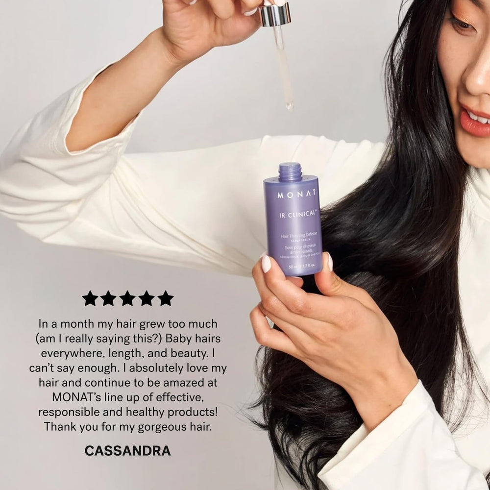 Hand holding MONAT bottle for size perspective and travel-friendly benefit