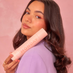 MONDAY HAIRCARE brunette beside everyday items demonstrating travel-friendly size