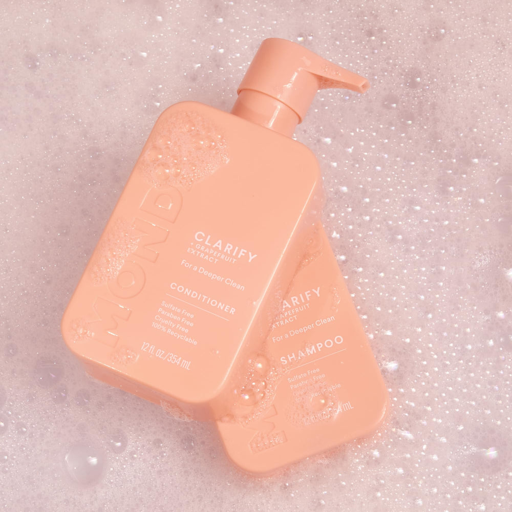 MONDAY HAIRCARE clarify on bathroom shelf alongside grooming items suggesting daily routine use