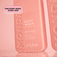 MONDAY HAIRCARE gardenia flowers beside bottle suggesting subtle fresh floral scent