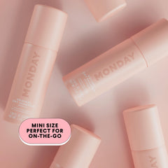 MONDAY HAIRCARE next to a smartphone to show 50ml size and portability for on‑the‑go use