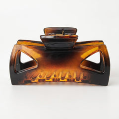 Morhom brown clip front view showing polished acetate and strong hold