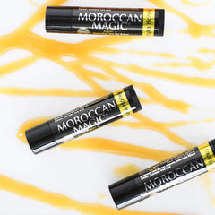 Moroccan Magic lip balm tucked in a bag depicting travel-ready care and everyday convenience benefit