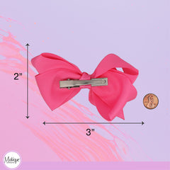 Motique Accessories bow clipped in a child's hair demonstrating comfortable wear and style