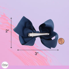 Motique Accessories bow worn in a little girl's ponytail for polished look