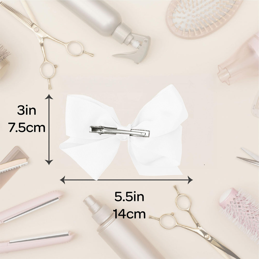 Motique Accessories bow next to hand to show true size and scale